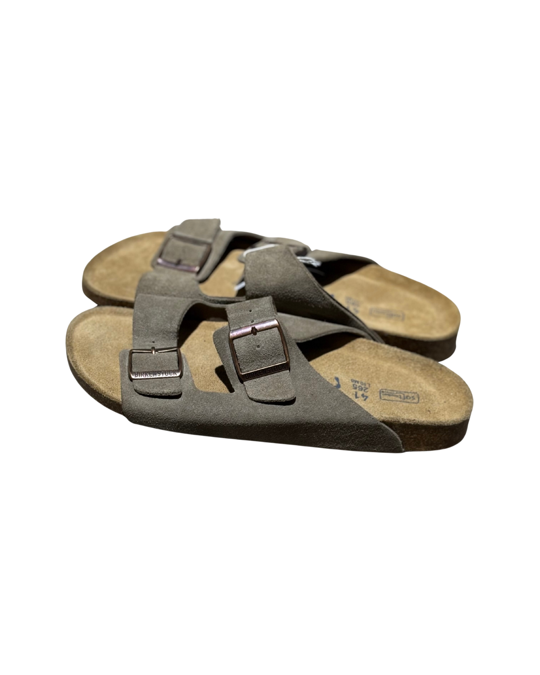 Pair of brown sandals with straps on a white background