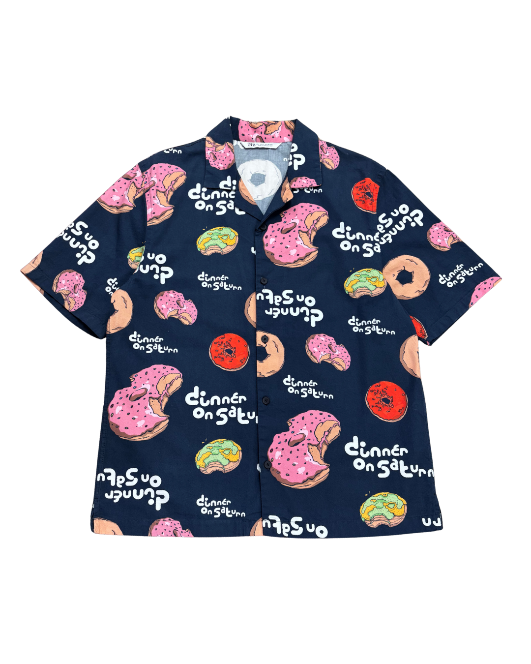 Navy blue shirt with colorful donut and text pattern on a white background