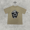 Sand-coloured short-sleeve crew-neck T-shirt with a large black-and-white face graphic on the front.