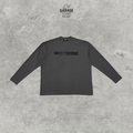 Charcoal WE11DONE long-sleeve crew-neck T-shirt with a tonal black chest logo, shown flat from the front.